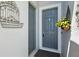 Charming entryway featuring a gray front door with decorative flower basket, adding curb appeal at 15793 Midnight Dove Ct, Odessa, FL 33556