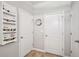 Neutral hallway with multiple storage options and light-colored walls at 15793 Midnight Dove Ct, Odessa, FL 33556