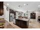 Gourmet kitchen with granite countertops, stainless steel appliances, and a large island with seating at 15793 Midnight Dove Ct, Odessa, FL 33556