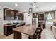Gourmet kitchen with granite countertops, stainless steel appliances, and a large island with seating at 15793 Midnight Dove Ct, Odessa, FL 33556