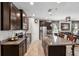 Gourmet kitchen with granite countertops, stainless steel appliances, and a large island with seating at 15793 Midnight Dove Ct, Odessa, FL 33556