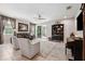Inviting living room featuring tile floors, neutral walls, a ceiling fan, and sliding glass doors to the backyard at 15793 Midnight Dove Ct, Odessa, FL 33556