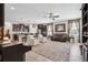 Open-concept living room showcasing tile floors, neutral walls, a ceiling fan, and stylish furnishings at 15793 Midnight Dove Ct, Odessa, FL 33556