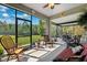 Relax in this screened-in patio with views of the home's luscious backyard at 15793 Midnight Dove Ct, Odessa, FL 33556