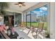 This view from the screen patio showcases the large backyard and beautiful Florida weather at 15793 Midnight Dove Ct, Odessa, FL 33556