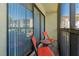 Balcony with two orange chairs and small table offering peaceful outdoor living at 1737 Pine Ridge W Way # B-1, Palm Harbor, FL 34684
