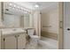 This tidy bathroom features a shower, large mirror with lighting, and a clean, tile floor at 1737 Pine Ridge W Way # B-1, Palm Harbor, FL 34684