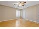 Bedroom featuring hardwood floors, fan, closet and window with attractive natural light at 1737 Pine Ridge W Way # B-1, Palm Harbor, FL 34684