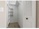 A white closet with ample shelving and storage space at 1737 Pine Ridge W Way # B-1, Palm Harbor, FL 34684