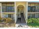 A close up shot of the building entrance with stairway to the upper units at 1737 Pine Ridge W Way # B-1, Palm Harbor, FL 34684