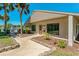 Exterior of community clubhouse with well-maintained landscaping at 1737 Pine Ridge W Way # B-1, Palm Harbor, FL 34684