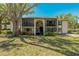 Two-story condo complex featuring balconies, mature landscaping and a large shade tree at 1737 Pine Ridge W Way # B-1, Palm Harbor, FL 34684