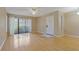 Bright, neutral living room with wood floors and natural light from the balcony doors at 1737 Pine Ridge W Way # B-1, Palm Harbor, FL 34684