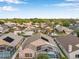 A vibrant aerial shot featuring multiple homes with screened-in pools on a sunny day at 1783 Wood Brook St, Tarpon Springs, FL 34689