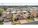 This aerial view showcases beautiful houses with solar panels in a peaceful neighborhood with blue skies in the background at 1783 Wood Brook St, Tarpon Springs, FL 34689