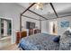 The main bedroom features a four-poster bed, light-filled windows, and elegant furnishings at 1783 Wood Brook St, Tarpon Springs, FL 34689