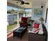 Enclosed patio featuring comfortable seating, vibrant artwork, and a serene view of the waterfront at 18345 Hottelet Cir, Port Charlotte, FL 33948