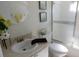 Well-lit bathroom with a shower and a decorative wall mirror at 19505 Quesada Ave # Bb-103, Port Charlotte, FL 33948