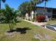 Condo building with green grass and tropical landscaping at 19505 Quesada Ave # Bb-103, Port Charlotte, FL 33948