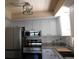 Modern kitchen with stainless steel appliances and white cabinets at 19505 Quesada Ave # Bb-103, Port Charlotte, FL 33948