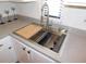 Kitchen sink with new faucet, cutting board, and cleaning supplies at 19505 Quesada Ave # Bb-103, Port Charlotte, FL 33948
