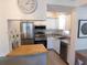 Modern kitchen with stainless steel appliances, countertops, and a breakfast bar at 19505 Quesada Ave # Bb-103, Port Charlotte, FL 33948