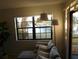 Cozy living room features a large window with a view of the lake at 19505 Quesada Ave # Bb-103, Port Charlotte, FL 33948