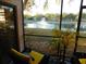 Screened porch with seating overlooking a serene lake and fountain at 19505 Quesada Ave # Bb-103, Port Charlotte, FL 33948