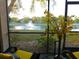 Charming screened porch with lake view and comfortable seating area at 19505 Quesada Ave # Bb-103, Port Charlotte, FL 33948