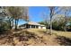 This house has a vast backyard, trees, and a screened-in porch at 2158 Fentress Ct, Spring Hill, FL 34609