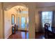 Inviting foyer with chandelier, decorative front door and sidelights, and hardwood floors at 2158 Fentress Ct, Spring Hill, FL 34609