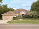 Charming single-story home with manicured landscaping, inviting curb appeal, and a two-car garage at 2158 Fentress Ct, Spring Hill, FL 34609