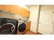 Laundry room features modern washer and dryer set at 2158 Fentress Ct, Spring Hill, FL 34609