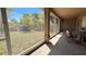 Enclosed porch with a view of the backyard, surrounded by trees at 2158 Fentress Ct, Spring Hill, FL 34609