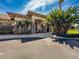 Beautiful community clubhouse featuring stone accents, arched entryway, and lush tropical foliage at 2634 Ravendale Ln, Holiday, FL 34691