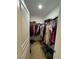 Spacious walk-in closet offers plenty of room for clothing storage with rods and overhead shelving at 2919 E 31St Ave, Tampa, FL 33610
