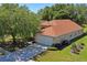 A charming home with a well-maintained roof, lush landscaping, and a spacious driveway for easy parking at 303 Rochester St, Spring Hill, FL 34609