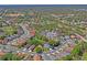 Expansive aerial view of a suburban neighborhood with lush greenery and well-spaced homes in a serene setting at 303 Rochester St, Spring Hill, FL 34609