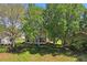 A beautiful backyard featuring a patio and lush landscaping for outdoor enjoyment and privacy at 303 Rochester St, Spring Hill, FL 34609
