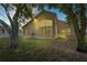 Spacious backyard featuring a large glass wall, ideal for seamless indoor-outdoor living and natural light at 303 Rochester St, Spring Hill, FL 34609