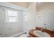 Bathroom featuring a mirror, a toilet, and a combined shower and bathtub at 303 Rochester St, Spring Hill, FL 34609