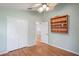 Bedroom featuring hardwood floors, a closet, and a ceiling fan at 303 Rochester St, Spring Hill, FL 34609