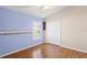 Bedroom with blue accent wall, wood floors and a ceiling fan and vaulted ceilings at 303 Rochester St, Spring Hill, FL 34609