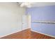 Bedroom with blue accent wall, wood floors and a ceiling fan and vaulted ceilings at 303 Rochester St, Spring Hill, FL 34609
