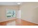 Bedroom featuring a window with views of the outdoors, and hardwood floors at 303 Rochester St, Spring Hill, FL 34609