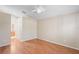 A neutral bedroom with hardwood floors, high ceilings, and a ceiling fan at 303 Rochester St, Spring Hill, FL 34609