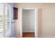 Walk in closet with multiple shelves and wood flooring in neutral colored room at 303 Rochester St, Spring Hill, FL 34609