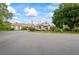 Charming clubhouse view with mature trees, manicured bushes and green grass at 303 Rochester St, Spring Hill, FL 34609