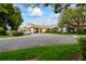 Beautifully maintained clubhouse with lush landscaping and ample parking for residents and guests at 303 Rochester St, Spring Hill, FL 34609