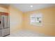 Eat-in kitchen nook with bright yellow walls and a window with white shutters at 303 Rochester St, Spring Hill, FL 34609